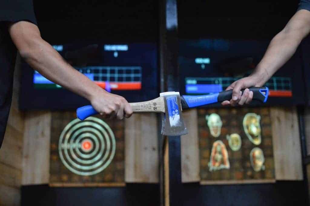 axe hatchets in front of axe throwing lanes
